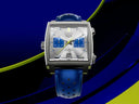 Luxury men's square chronograph watch with blue strap and blue subdials on modern background
